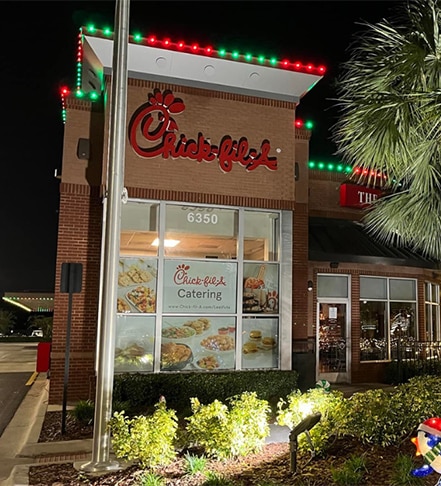 Commercial holiday lighting installation at Chick-Fil-A in Fishers, IN